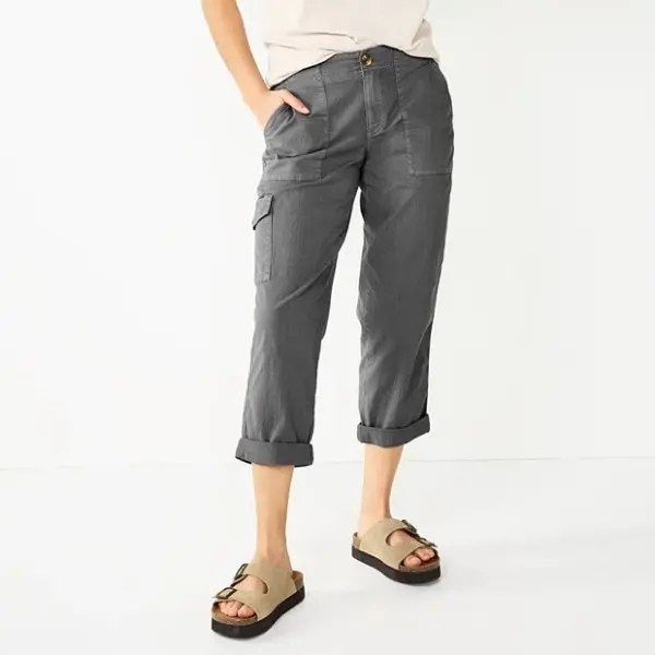 Woman wearing gray cargo capri pants with rolled cuffs and a side cargo pocket, styled with beige sandals
